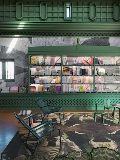 Interior shot of a dark green and gold themed law office with books and a calm atmosphere
