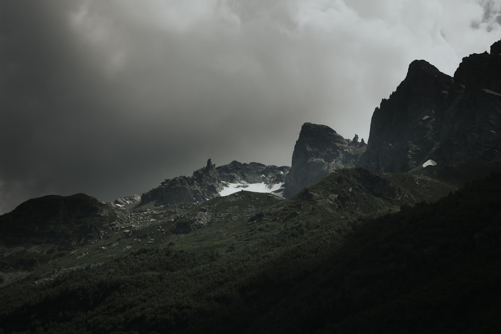 a group of mountains under a cloudy sky