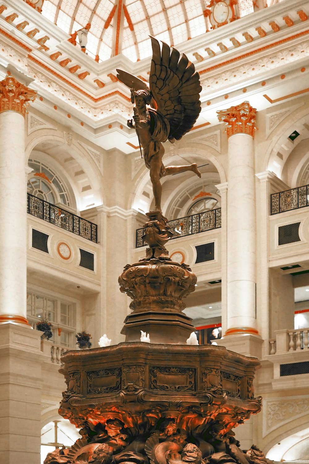 a statue of a bird on top of a fountain in a building