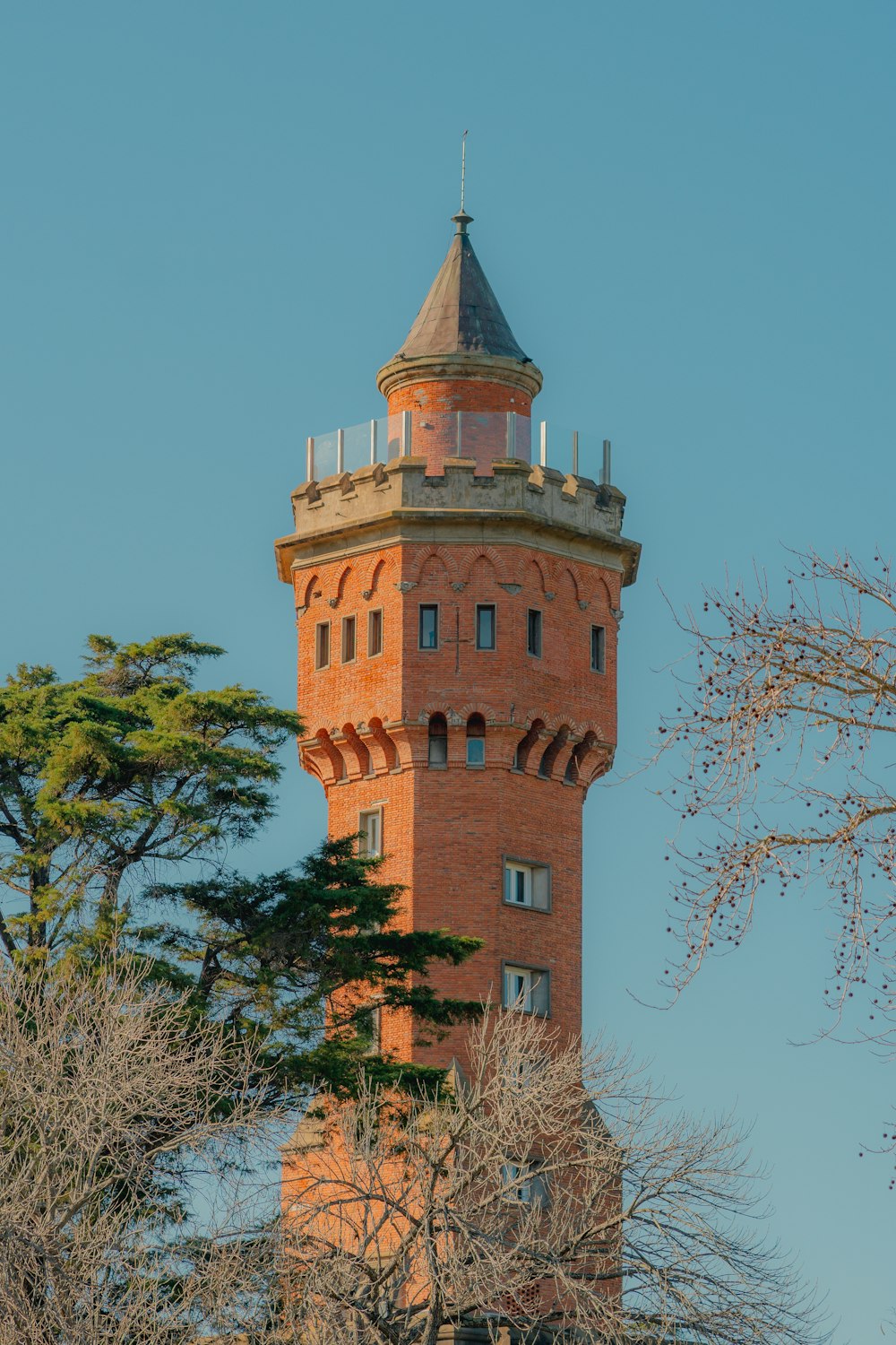 a tall brick tower with a clock on the top