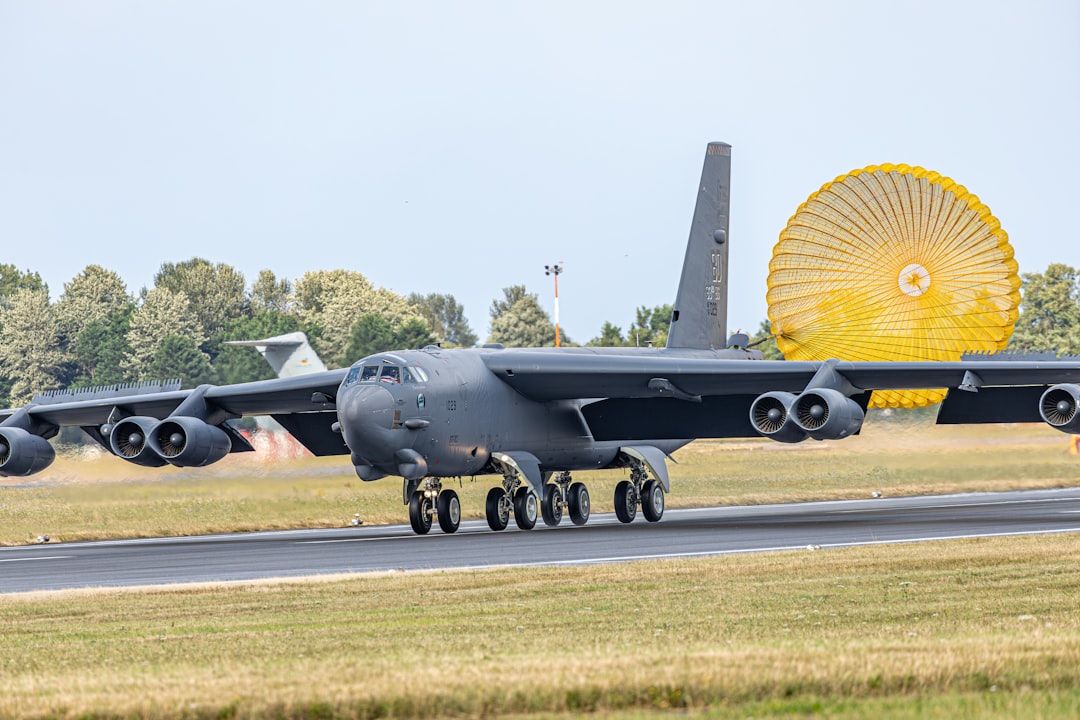 a large military plane on a run way, B-52 landing at Fairford for the royal international air tattoo