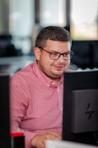 A professional office setting with a person using a computer to manage emails.