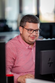 A technician assisting a client with a computer issue in a professional setting.