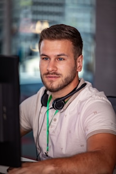 A man engaged in an online neurofeedback session at his desk.