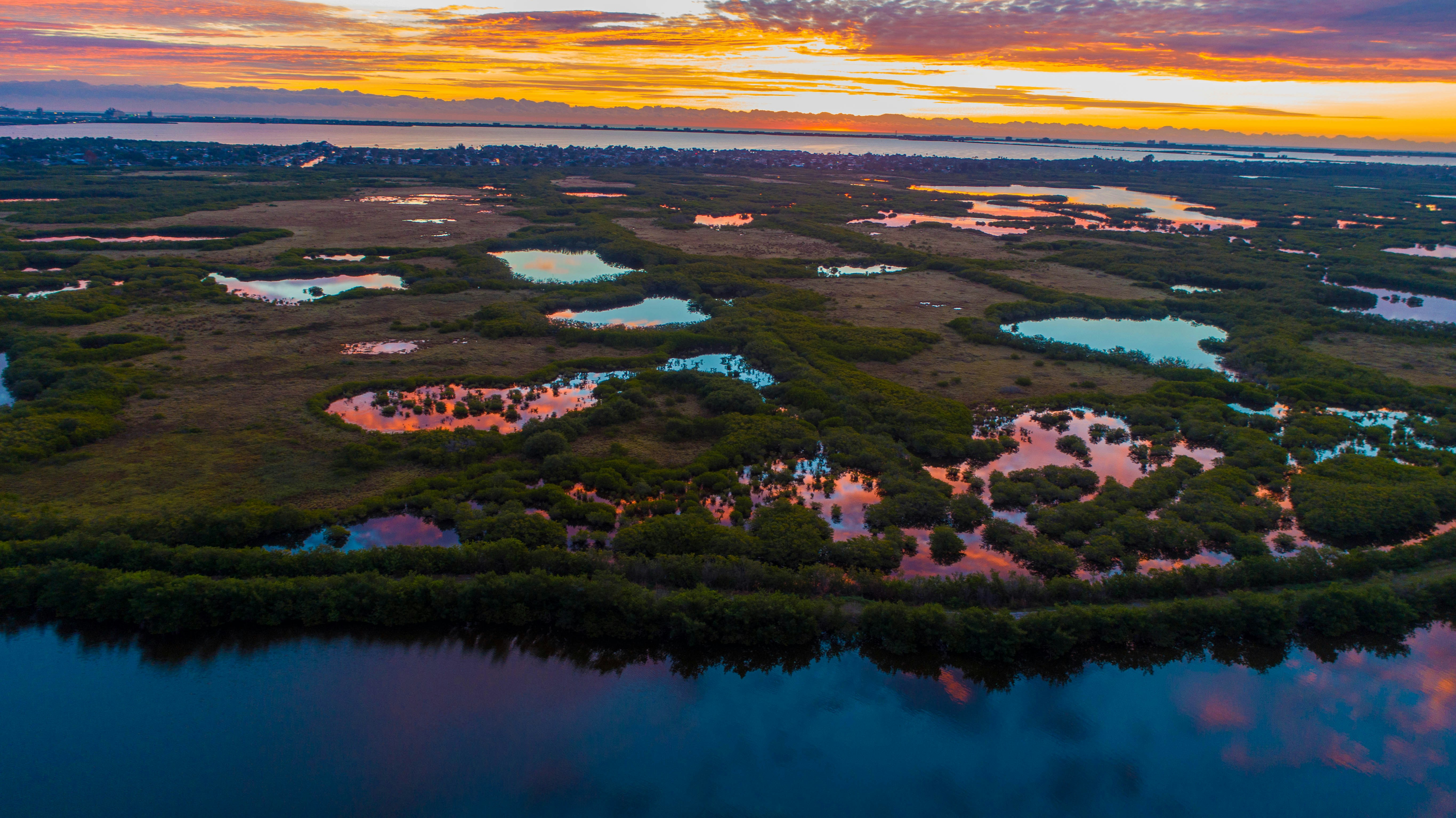 an aerial view of a lake surrounded by land