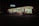 A brightly lit convenience store is visible at night, with a recognizable striped logo on its signage. The store has large glass windows and is surrounded by a darkened parking lot, with a vehicle and bicycles near the entrance. Inside, shelves and products are dimly visible under fluorescent lighting.