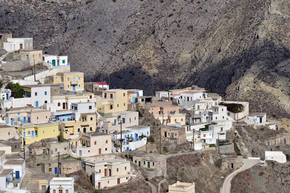 a village on a mountain side with a mountain in the background