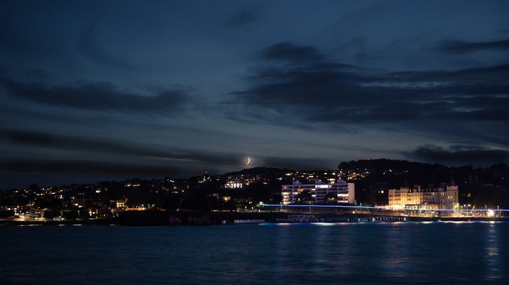 a view of a city at night from the water