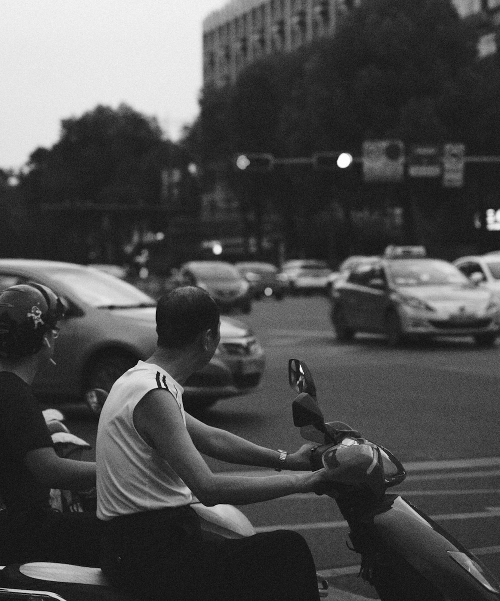 a couple of people riding on the back of a motorcycle