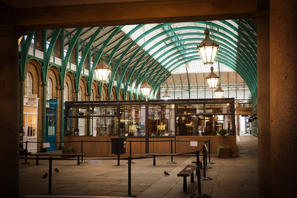 a train station with a bench and some lights