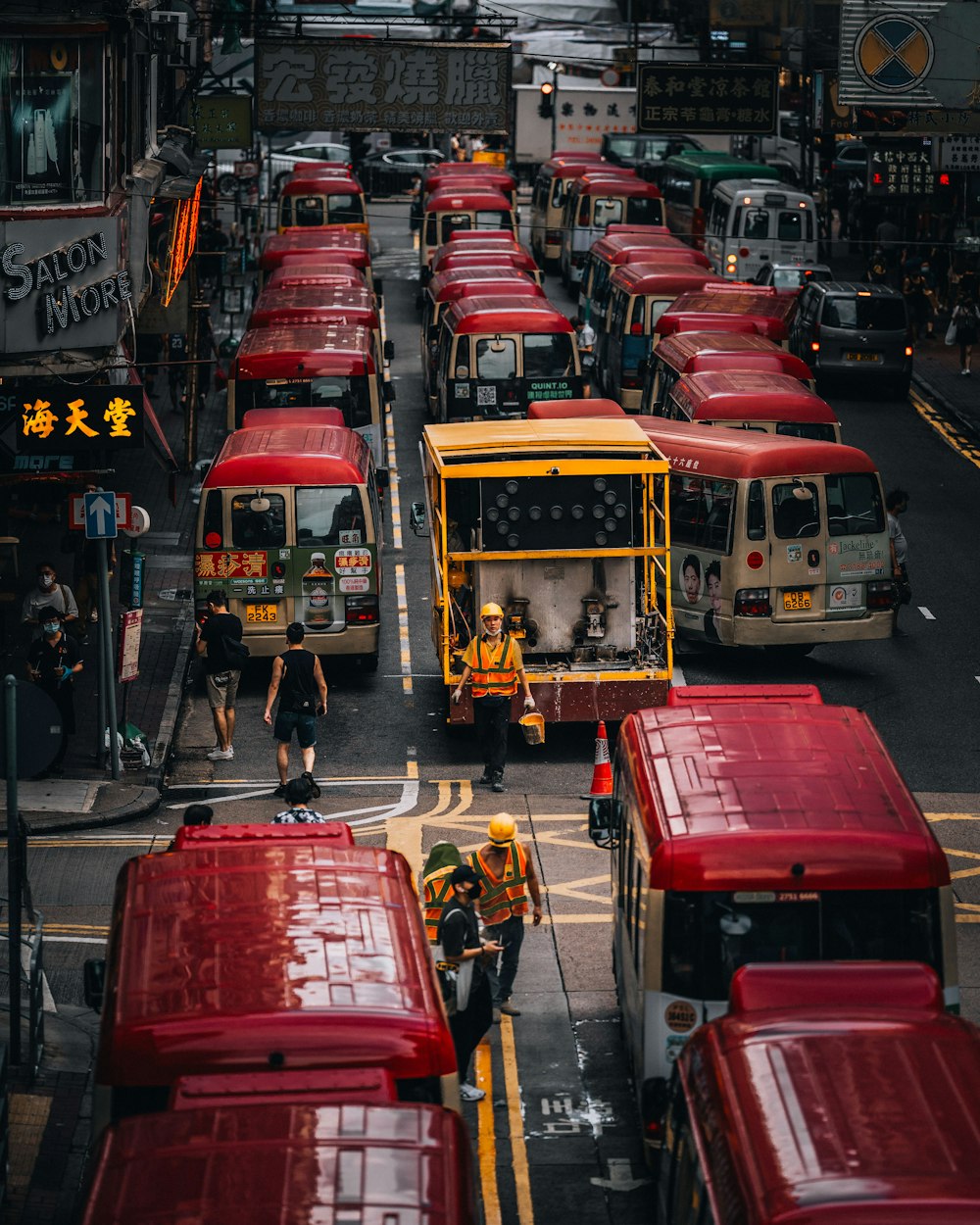 a street filled with lots of red buses