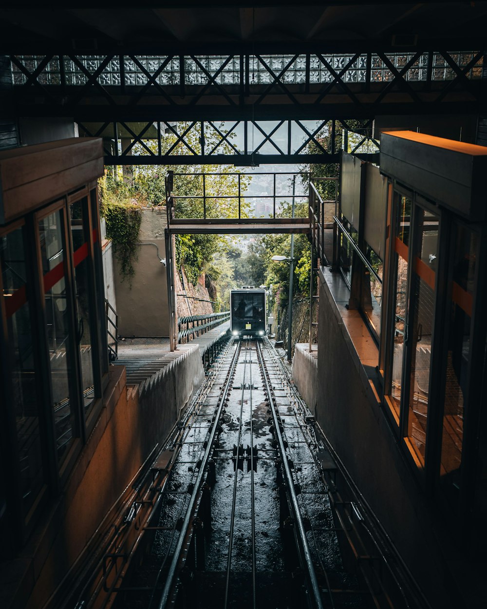 an overhead view of a train track in the rain