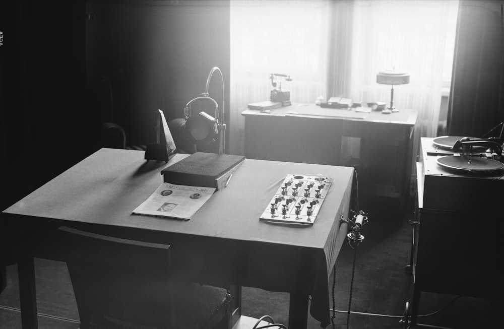 a black and white photo of a desk with a keyboard