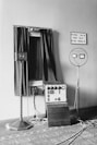 a room with a clock, a radio and a speaker