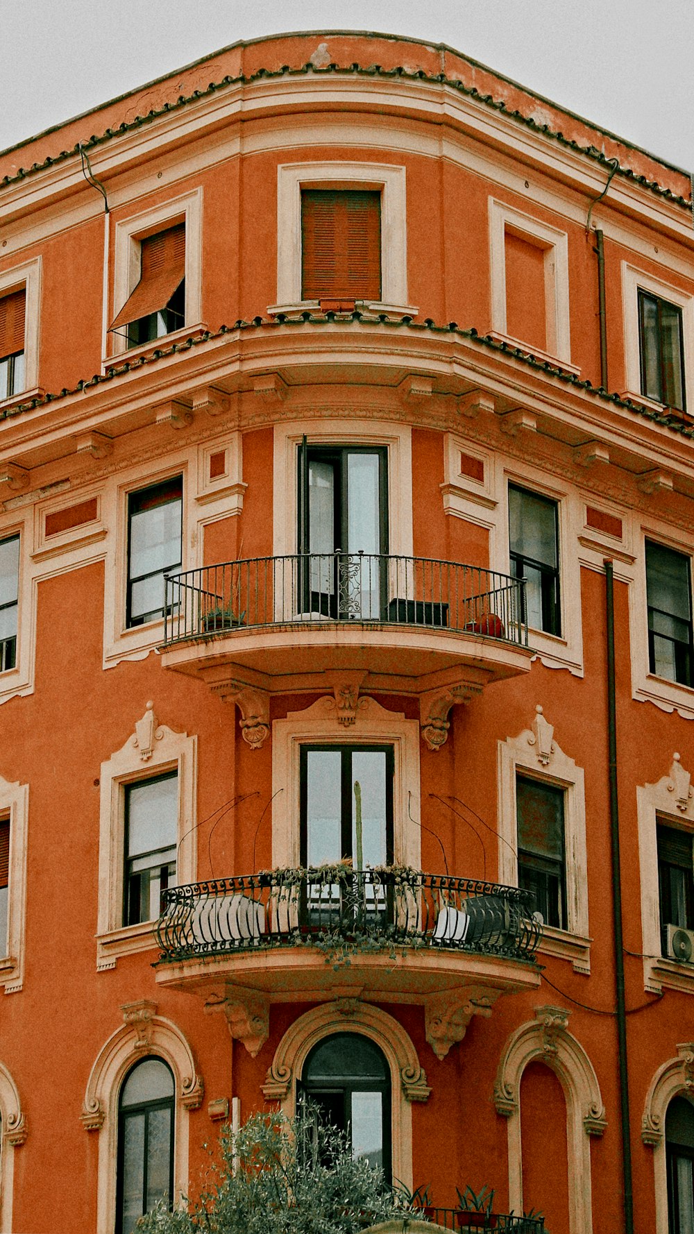 an orange building with balconies and balconies on the balconies