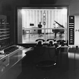 Black-and-white photo of the original WASA radio studio from 1948 with vintage microphones and equipment.