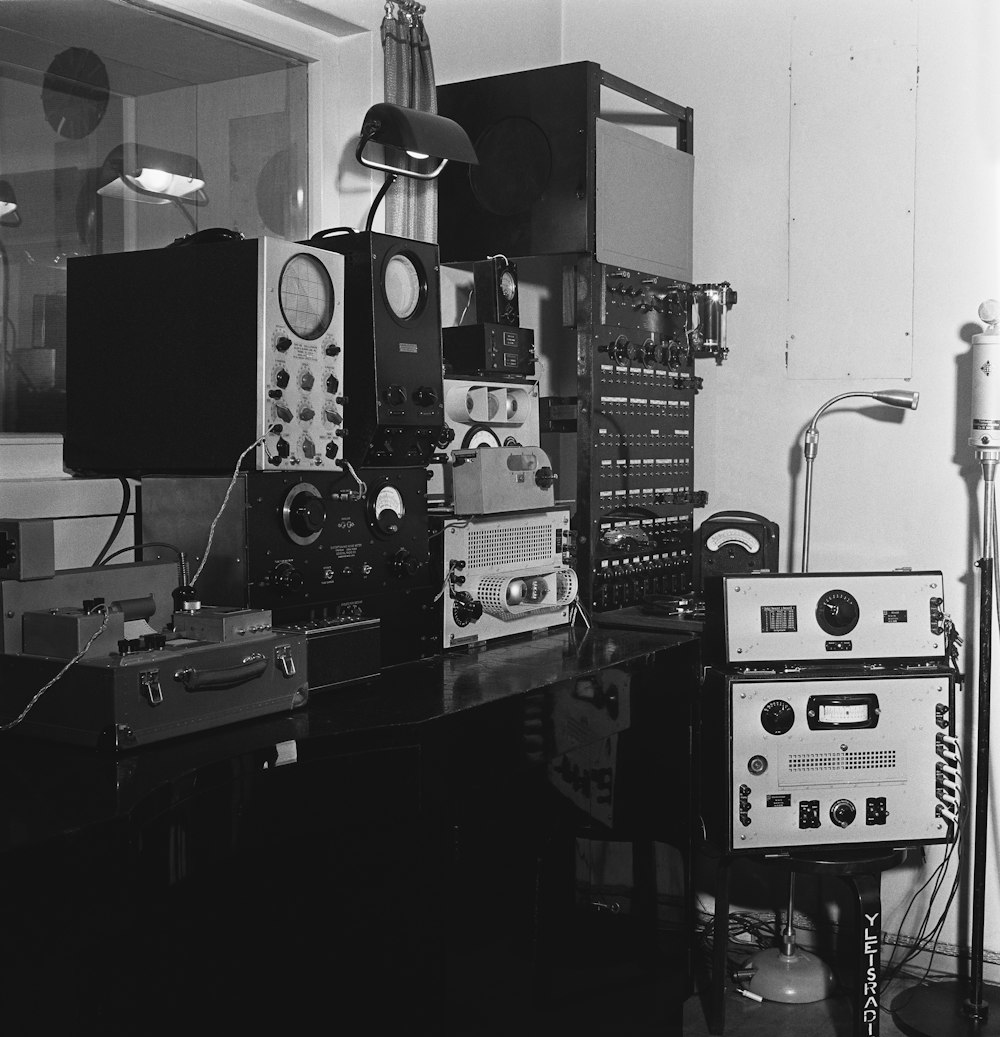 a black and white photo of a room full of electronics