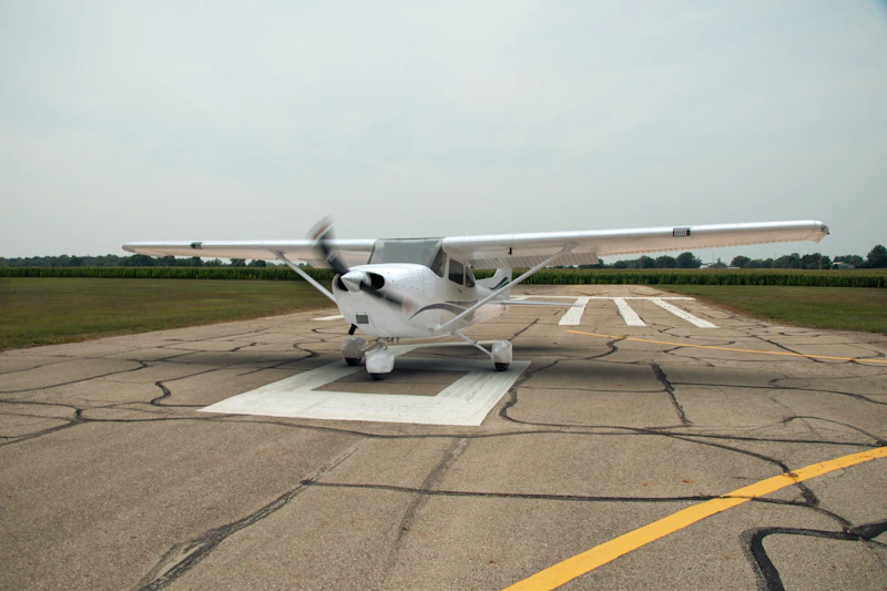 A single-engine training aircraft parked on the apron