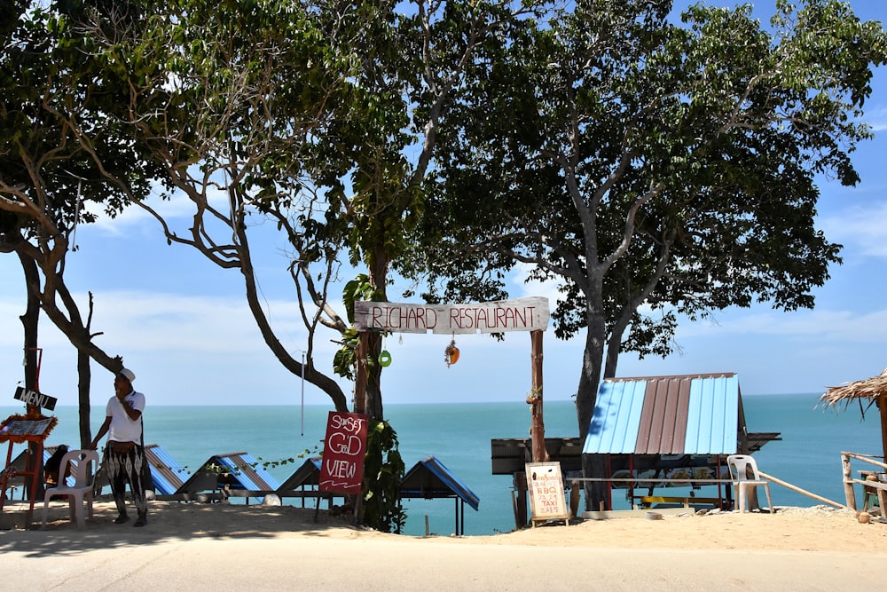 a group of people standing on top of a sandy beach