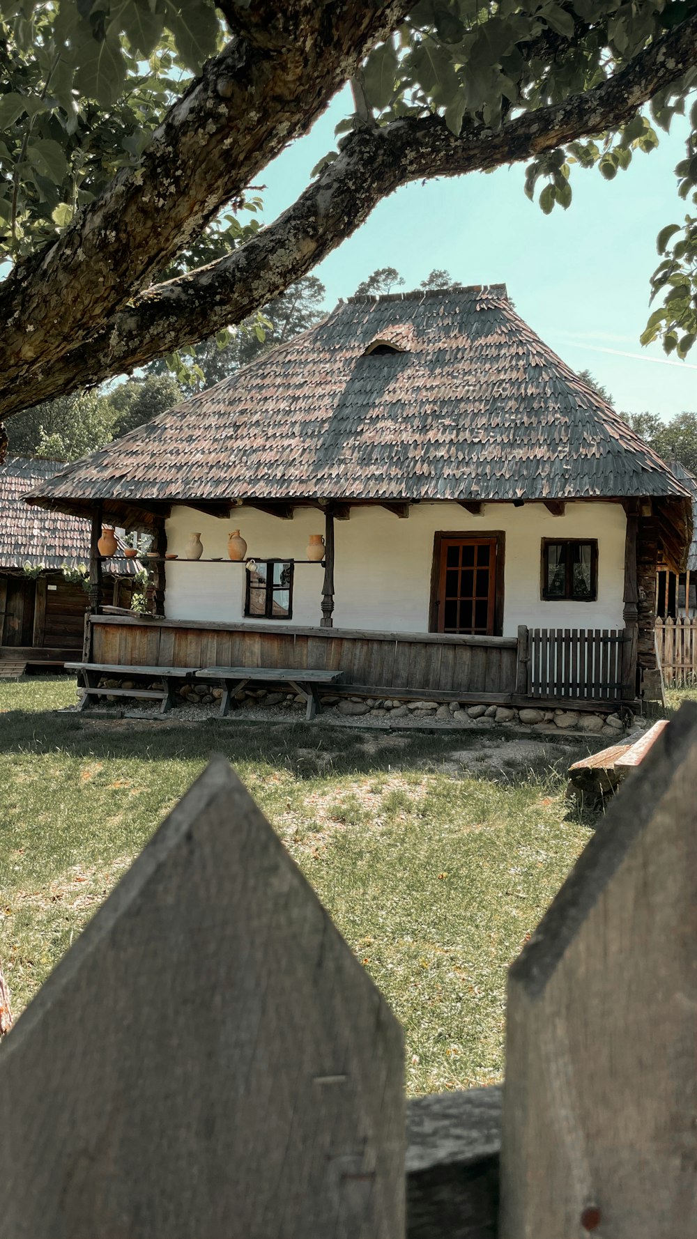 a small white house with a thatched roof