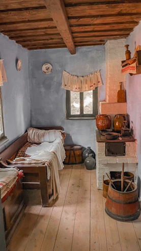 Charming studio apartment with rustic decor and cozy bed.