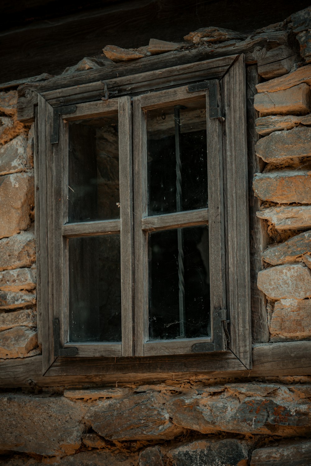 a window in a stone building with a wooden frame
