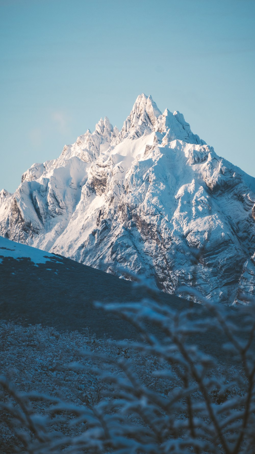 a snow covered mountain is seen in the distance