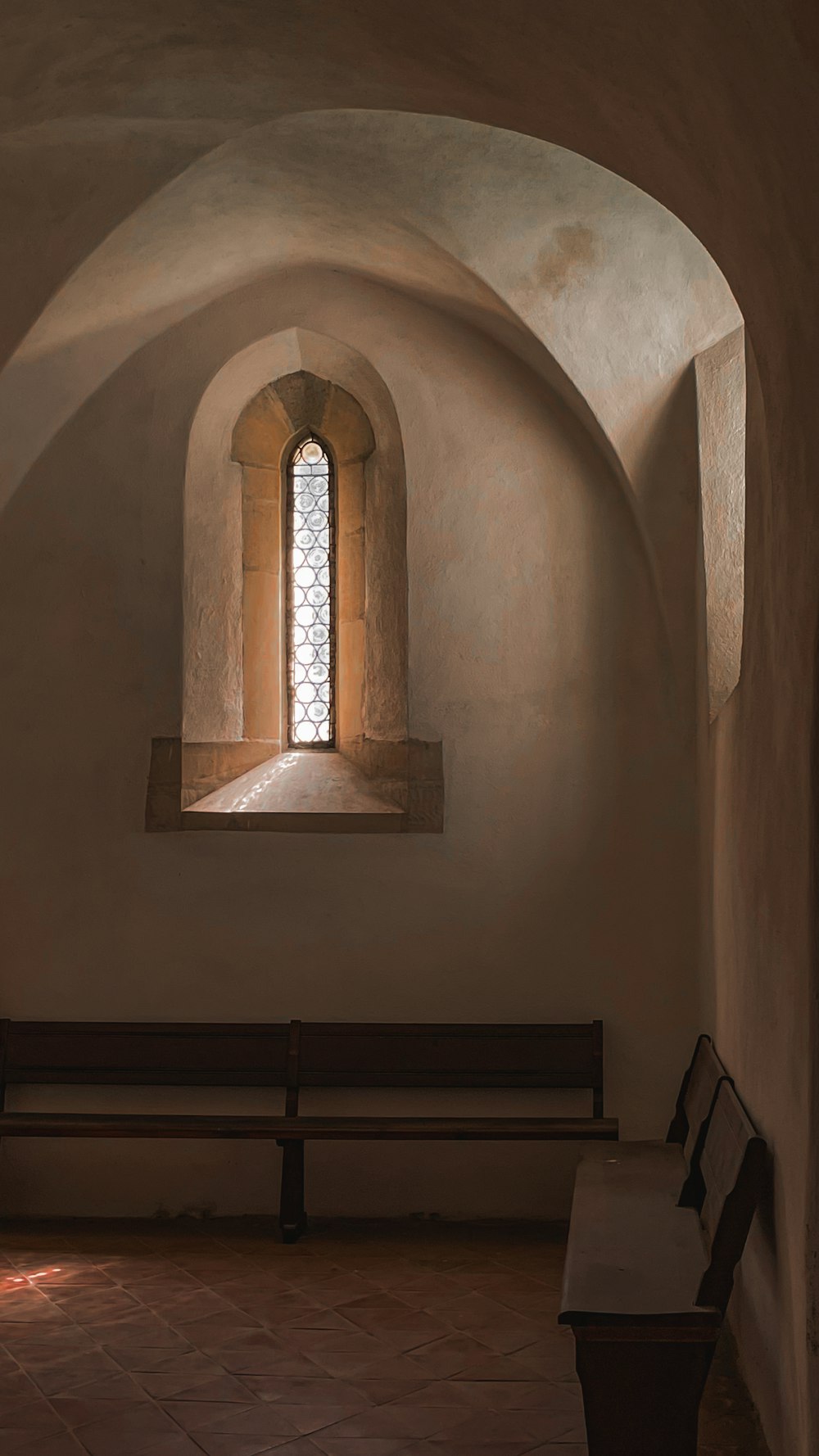 a church with a bench and a window