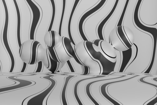 Abstract black and white scene with undulating stripes across the background and three-dimensional spherical shapes in the foreground. The stripes create a wave-like illusion and cover both the background and the objects, leading to a seamless visual effect.