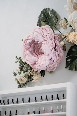 A welcoming manicure station with colorful nail polish bottles and fresh flowers on the table.