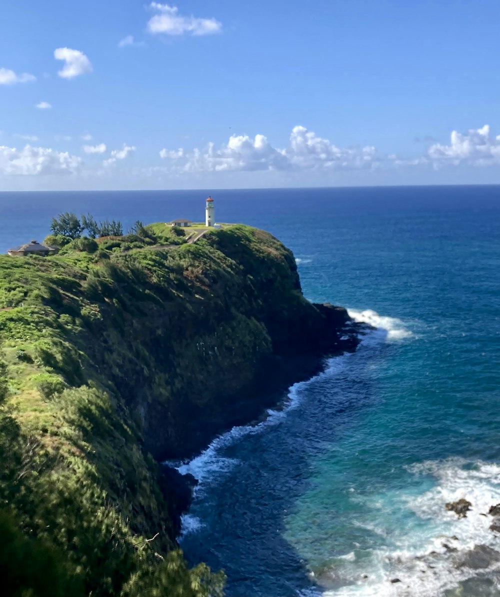 a lighthouse on a cliff overlooking the ocean