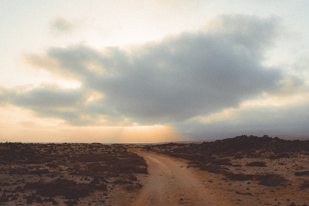 a dirt road in the middle of a desert