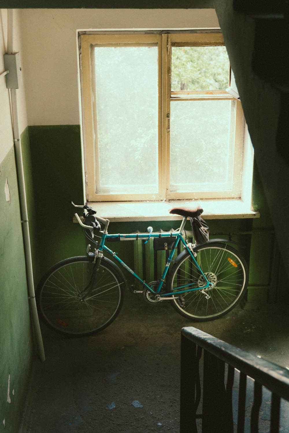 a bike is parked in front of a window