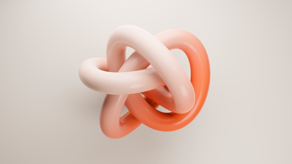 an orange and white knot on a white wall