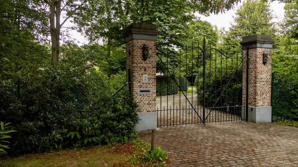 a brick gate with two gates and a brick walkway