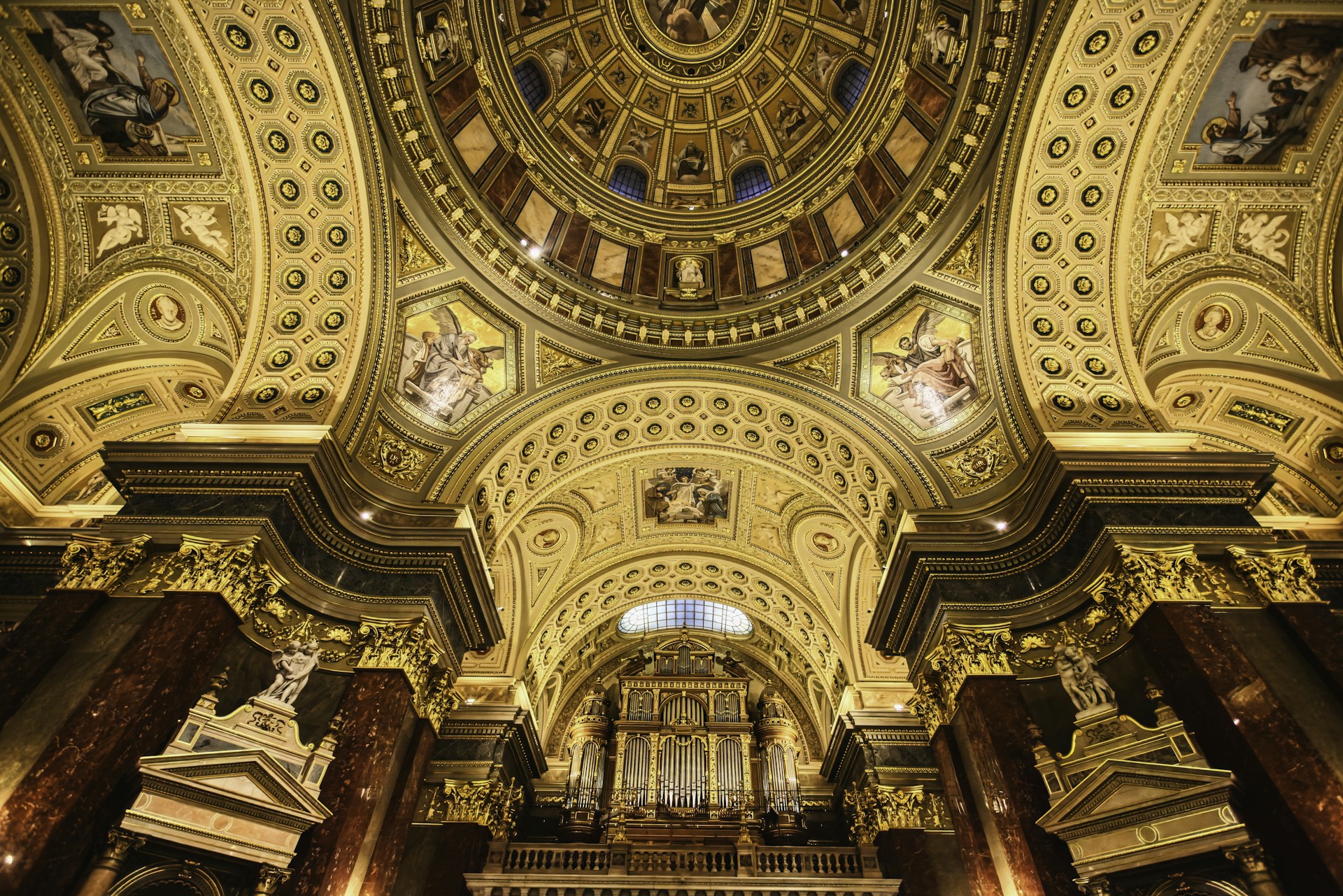 the ceiling of a large church with a clock on it