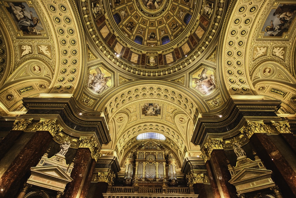 the ceiling of a large church with a clock on it