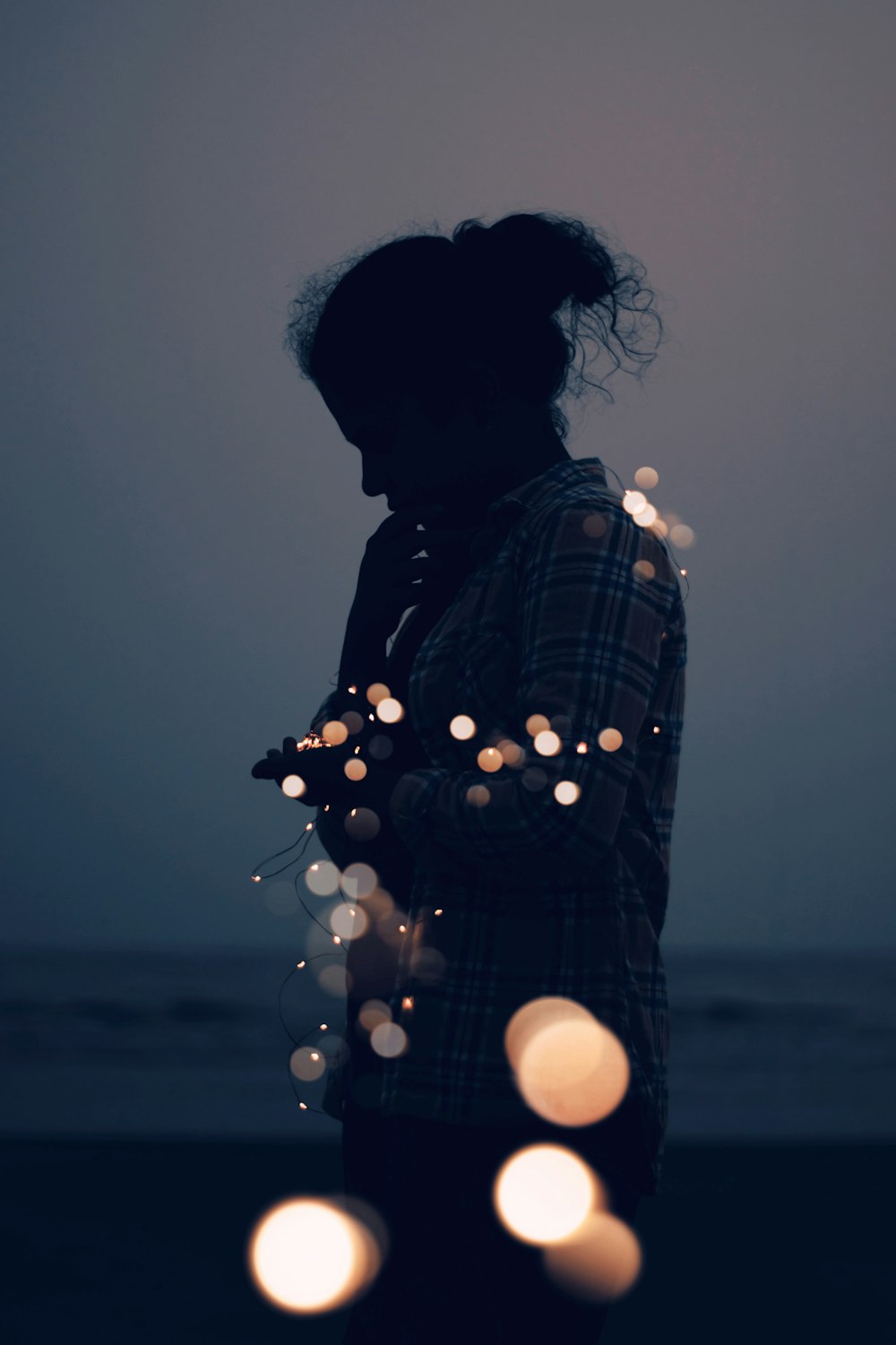 a person standing in front of some lights