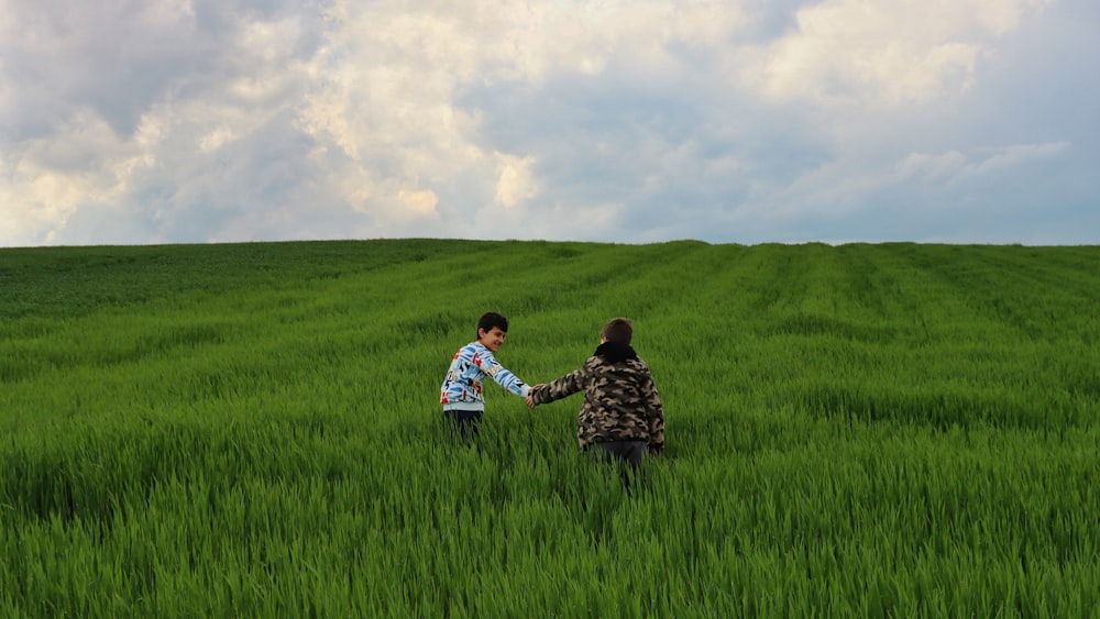 a couple of people that are in a field