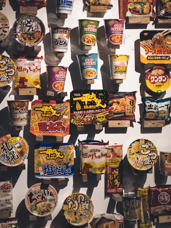 Packaging samples showcasing custom designs for OEM/ODM instant noodle products with a clean, modern look.