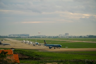 A panoramic view of the Munich Airport runway with several planes lined up, ready for departure.