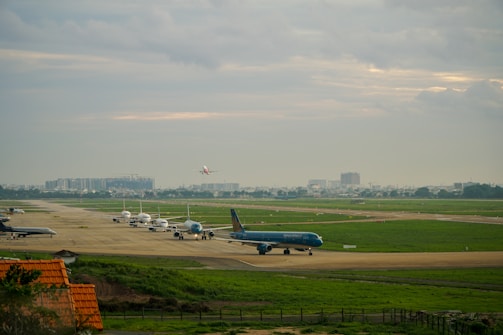 A panoramic view of the Munich Airport runway with several planes lined up, ready for departure.