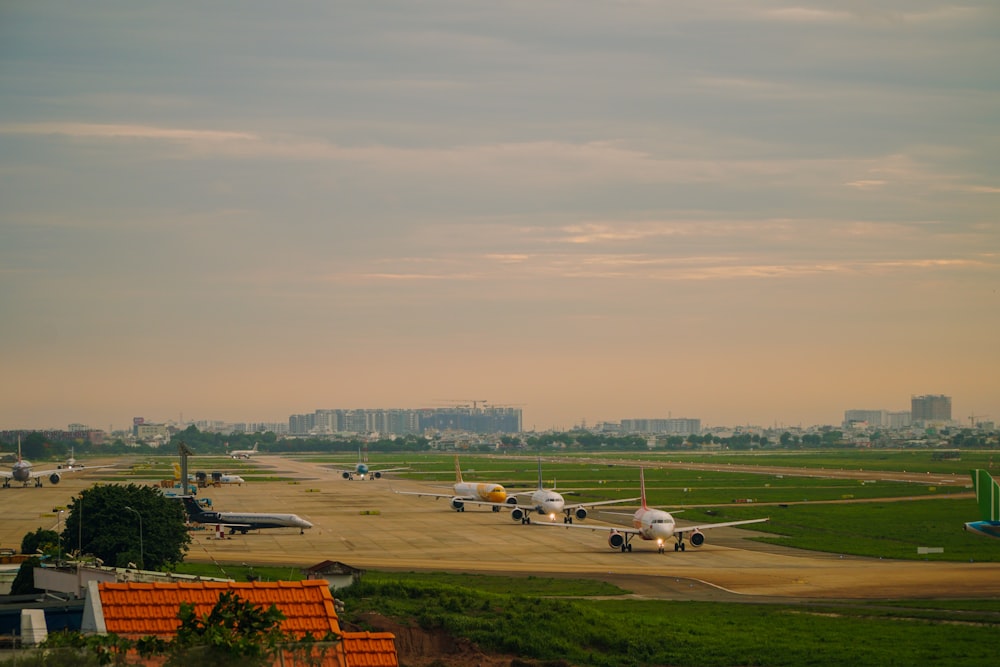 a group of airplanes are parked on a runway
