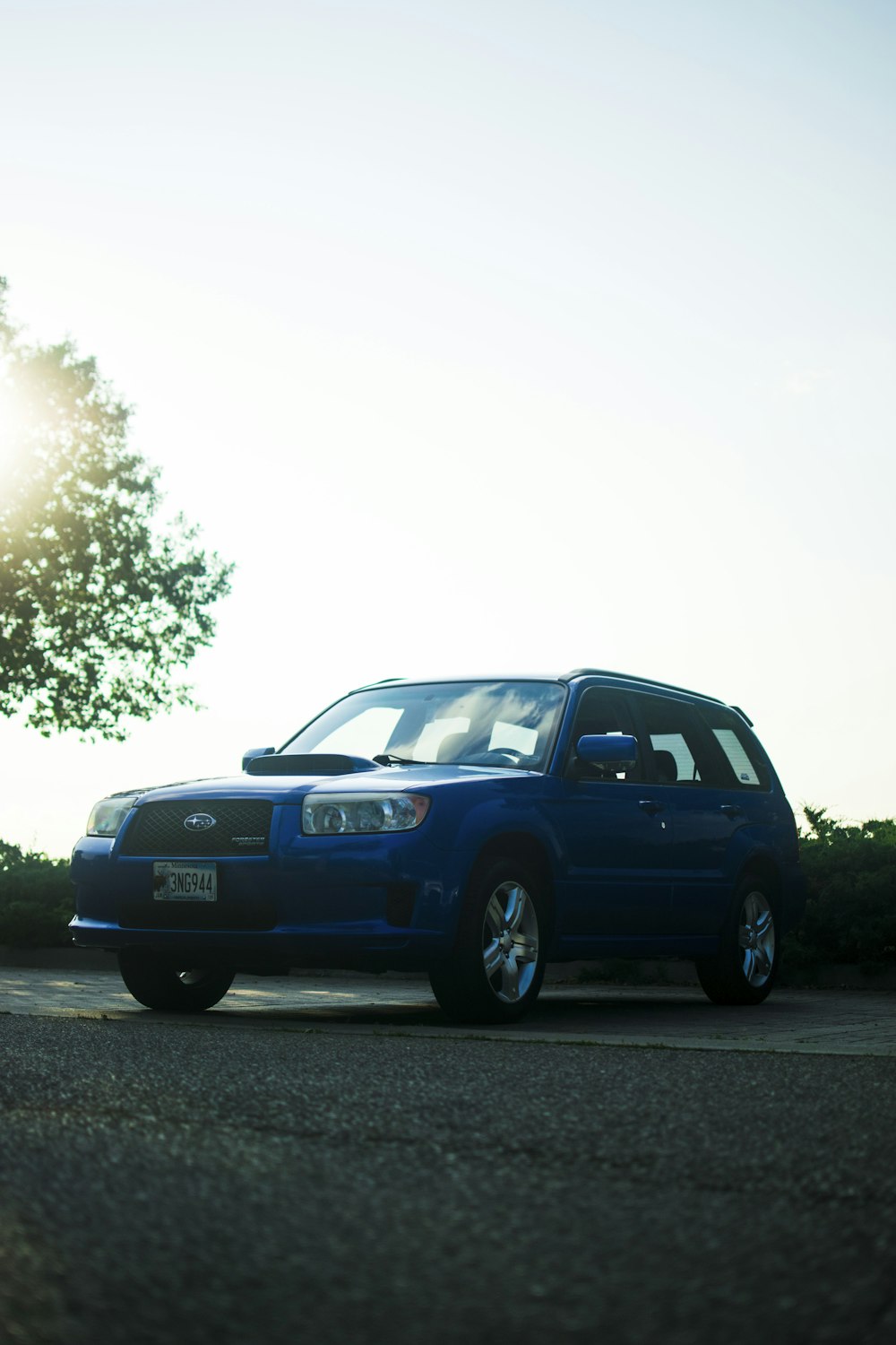 a blue car parked on the side of the road