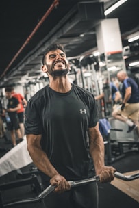 A determined man lifting heavy weights in a gritty gym setting.
