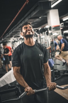 Men pushing through a tough workout in a gritty gym setting, sweat and determination visible.