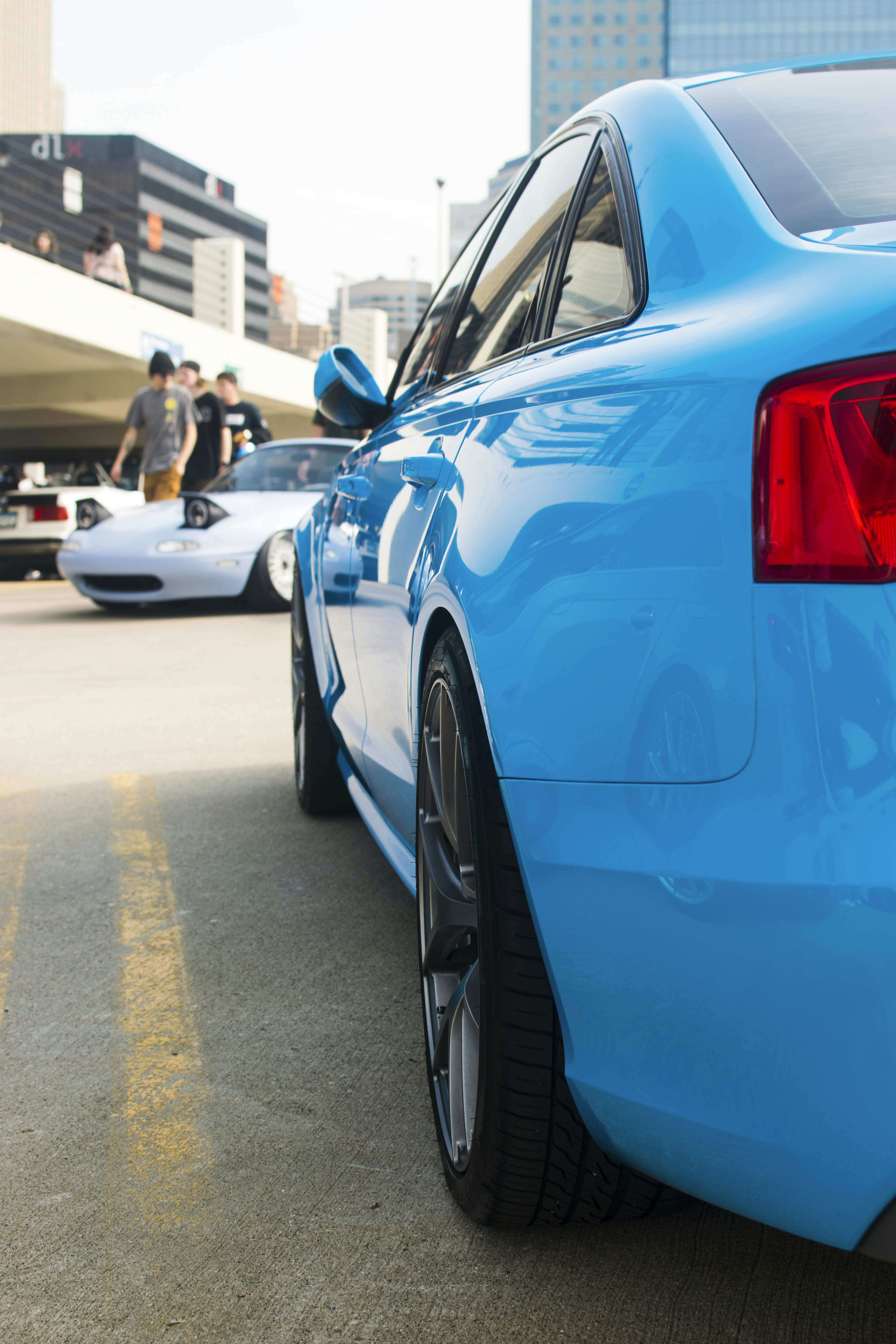 a blue car parked on the side of the road