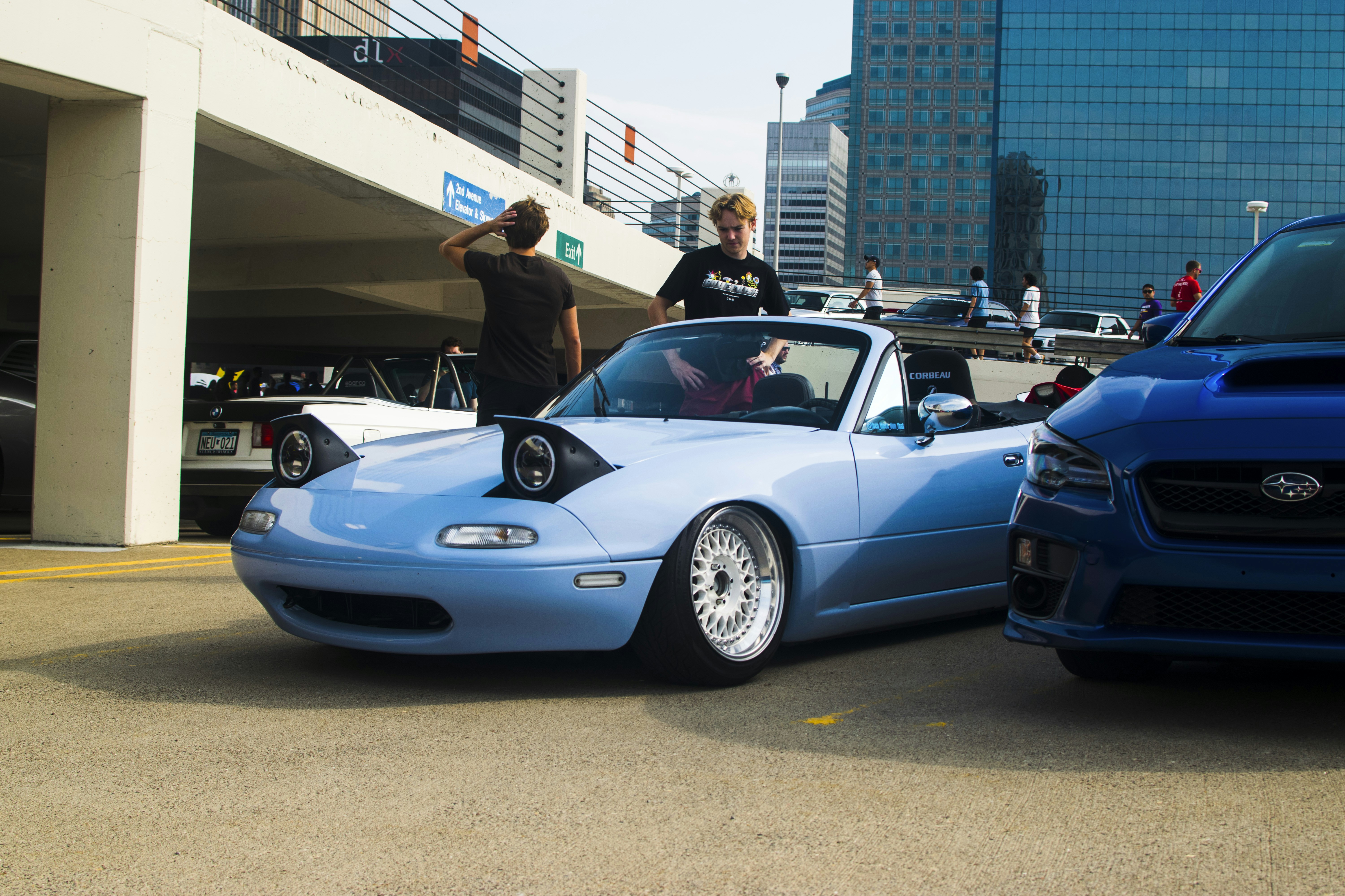 a blue sports car parked next to a blue sports car