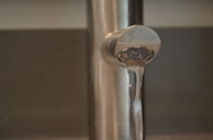 A close-up image of a reverse osmosis filter with clear water flowing through.