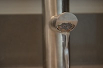 Close-up of water flowing smoothly from a newly repaired faucet.